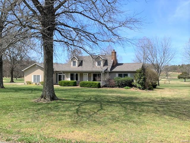 Here it is!!! The Golf Lovers Delight!! This Cape Cod Style home has an awesome view of #16 Fairway at the beautiful Hidden Trails Golf Course!! This 2097 square foot - story and a half home - sits on two lots with a total of 1.19 acres. This home was built in 1990 and has a brick wood burning fireplace in the living room and scraped wood-look flooring in the living room, dining  room, kitchen, half bath, and laundry room. There are two heating and cooling central LP units in the home. The primary bedroom is on the main floor with ensuite bath that has lots of cabinetry and tub/shower unit and walk-in closet. All interior doors are six panel solid wood doors. The kitchen has an island and range top, wall oven, refrigerator, and dishwasher. Andersen thermopane windows throughout the house. There is also a spacious breezeway with glass doors that offer beautiful views...front and back. The upstairs features two bedrooms with dormer windows &amp; window seats/storage &amp; walkin closets.
