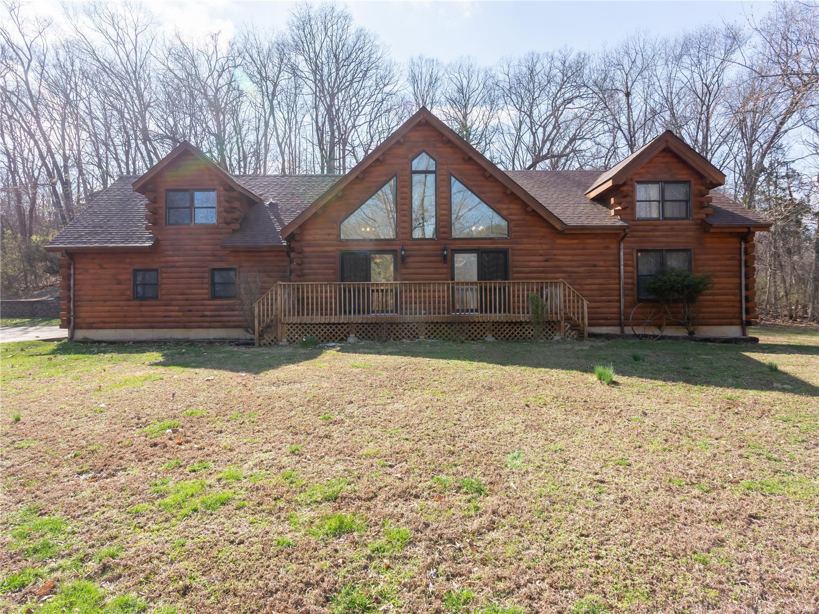 Welcome to 5023 Brook Dr, where rustic charm meets modern convenience. This stunning log home boasts spacious living areas and breathtaking views. Enjoy the warmth of the floor to ceiling stone fireplace as you relax in the great room looking out the wall of windows or prepare meals in the well-appointed kitchen. With 3 bedrooms and 3 bathrooms, this home offers plenty of room for families or guests. The primary suite features a private balcony overlooking the expansive yard. The finished lower level provides additional living space, along with a flex room perfect for home office or gym. But that's not all…this property also includes a massive 1,920 sf garage with two car lifts, infrared heater, A/C, newer panel & wiring, newer insulation, making it a car enthusiast's dream. There is also an attached carport, large enough for multiple vehicles, boats, etc. Also out back is a 47 x 27 patio area, complete with inlaid fire pit. Don't miss your chance to own this one-of-a-kind property. Additional Rooms: Mud Room