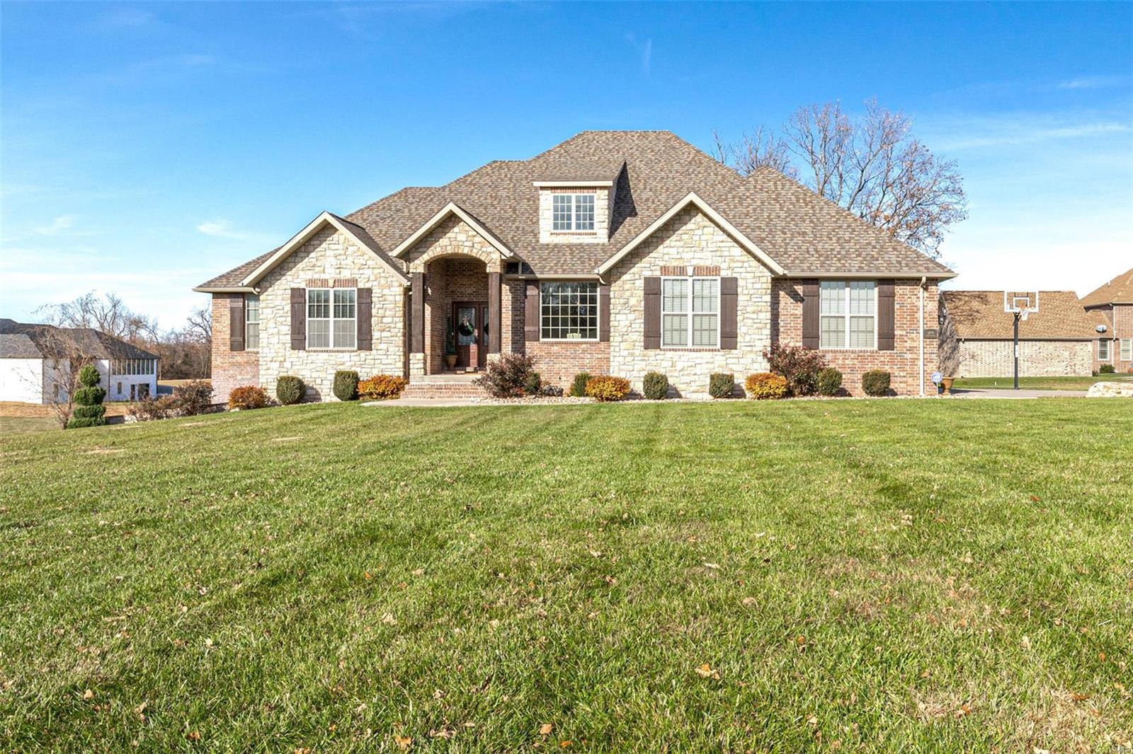 Looking to live in a Very Desirable Subdivision in Lebanon, Mo? Then this is the home for you! This home has 5 bedrooms, 3.5 bathrooms, 3 car garage, plus additional John deer garage, a formal dining room, along with a dining area in the kitchen. The kitchen is complimented with a huge island, custom cabinetry and granite countertops. The living room has a gas fireplace with stone to the ceiling and large open arch entries. The basement has 9 foot ceilings, kitchen/bar area, dining, living room with 2nd fireplace, 2 bedrooms, 1.5 baths and a John deer garage.
You will have plenty of room for outside entertaining with the in-ground pool, covered deck, and lower patio porch. This home is close to shopping, schools, parks, hospital and easy access to 1-44.