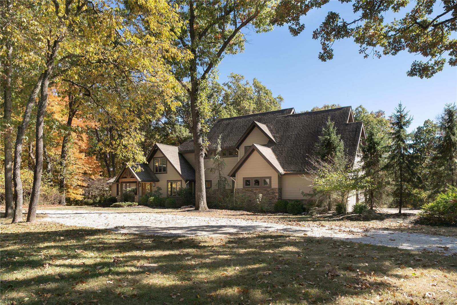 This magnificent Colorado-style recreational farm estate is set on 4 lush acres in Wildwood and feels like a vacation spot, just minutes from Chesterfield Valley. Beautifully appointed and meticulously maintained, the 4 bed, 3.5 bath property boasts an open floor plan & expansive windows, with incomparable views of the level yard, idyllic barn & surrounding woods. Honed timbers, stone & oak details highlight the dining room, bar & great room. The kitchen is a gourmet's dream, & the adjoining breakfast features an alderwood vaulted ceiling. With special features too numerous to mention, the main-floor master suite, second floor bonus rooms and two additional bedrooms are private and sophisticated. The lower level includes a fourth bedroom, family room, enviable media & rec room. The horse-ready grounds are just as stunning; the stone patio, fenced pastures, 3-stall barn, shed, chicken coop, & acres of trees create a magical setting. Lafayette schools complete this wonderful opportunity. Additional Rooms: Mud Room