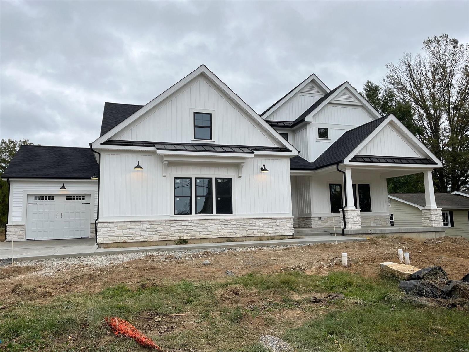 Spectacular modern farmhouse 1.5 story under construction by Boulevard Custom Homes.  This 5 bedroom, 4.5 bath, home features astounding finishes which include a 3-car side entry garage, hardwood flooring 1st floor and 2nd floor hall, gourmet kitchen with true custom cabinetry, large island and peninsula counter, crown molding, soft close drawers, 3 lazy susan's, pull-out spice rack, trash pullout, Quartz countertops, stainless steel appliances, under cabinet lighting, large walk-in pantry, built-in lockers, and impressive screened in rear porch.  12' high beamed ceiling in great room offers a fireplace, wine bar with wine cooler,  den/study with wainscot. Elegant master bath suite has coffer ceiling, large walk-in closet, adult height vanities, stand alone tub in master bath. Other amenities include wood front door,  wood treads on stairs, expansive 2nd floor bonus room, 2 full baths on 2nd floor, large bedrooms w/walk-in closets.  Finished lower level with rec room, bath, and bedroom Additional Rooms: Mud Room, Sun Room