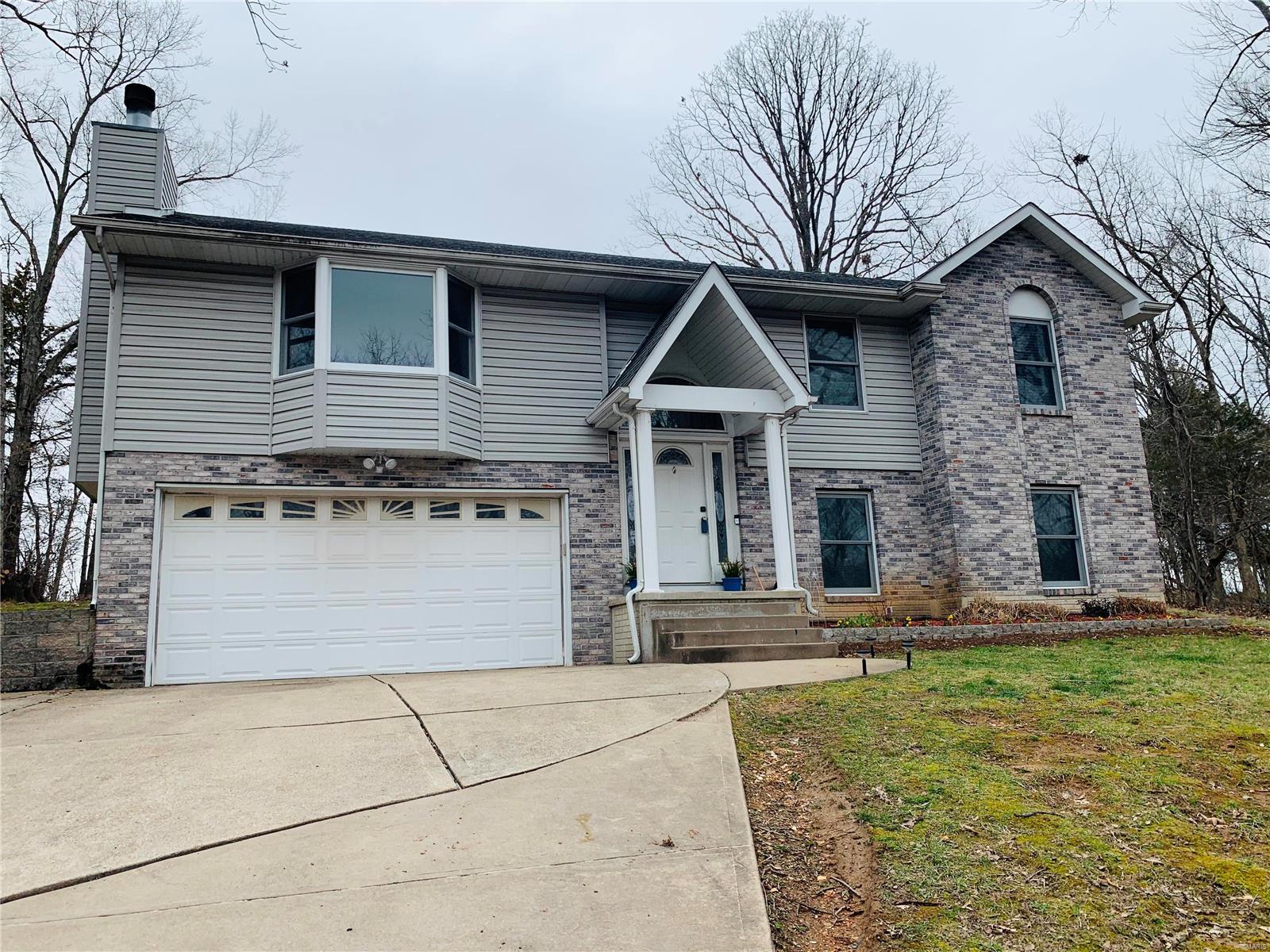 Vacation living all year long! With this spacious home you will have the best of both worlds in this gated lake community. It features 5 bedrooms, three bathrooms and 2,410 total sq ft. There are three bedrooms on the main level, with main floor master, and two additional bedrooms in the finished lower level. The lower level also features an office and rec area. The upstairs living area has a wood burning fire place, full dining area and vaulted ceilings. The kitchen has tons of storage and cooking space with a pantry, closet and center island.  It has been lovingly maintained with new flooring and paint. The furnace(16), ac(16) and hot water heater(18) have been updated as well. It is perfect for entertaining with the open concept living area and walk out deck. Continue outside to your expansive level backyard that backs up to the private golf course. You will never run out of outdoor activities with 4 lakes, 18 hole golf course, community pool and a campground in your own backyard.