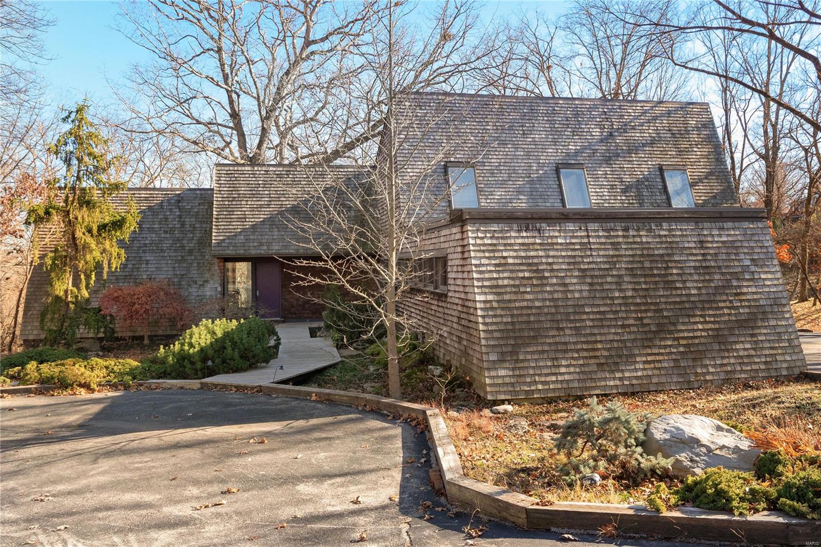 Welcome to a remarkable contemporary house nestled amidst the beauty of a wooded 3.65-acre lot in Town and Country. Upon entering, you'll be captivated by the thoughtful design, which ensures that every room captures views of the outside, connecting you to nature in every room. The main floor boasts a primary bedroom suite with enormous picture windows. The living room is a masterpiece of design, featuring floor-to-ceiling windows that offer another ever-changing panorama of the picturesque woods, a massive fireplace, and a hidden wet bar. The kitchen features custom white cabinets, a Subzero fridge, large windows and a door leading to the wrap-around deck. Open to the kitchen, you'll find a dining room. Main floor laundry. Upstairs, discover 3 bedrooms, and a full bath. The finished walk-out lower level adds even more living space, complete with another bedroom, full bath, vast recreation room, and storage. 2-car garage. Close to Queeny Park.