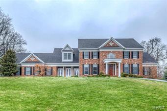 Magnificent 1.5 sty Estate home blends exceptional craftsmanship with contemporary amenities! Grand 2-sty marble foyer highlighted by sweeping staircase leads to handsome library with custom built-ins, elegant dining room & spectacular 2-sty great room with fireplace flanked by palladian windows, wet bar & atrium door to private patio. Exceptionally large kitchen with granite countertops, custom cabinetry, professional quality appliances, double islands & planning center adjoins breakfast room with French doors to covered porch & barrel-vaulted hearth room with stone fireplace & built-in bookcases. Sumptuous master bedroom suite with bay window & marble bath with fireplace & Jacuzzi. 4 Additional bedrooms, 2 with private baths & 2 with Jack n’ Jill bath, complete the living quarters. Incredible walk-out Lower Level features recreation room with wet bar, media room, workout room & bath. Extensively landscaped 1+ ac lot includes patio with brick fireplace, circular drive & 3-car garage.