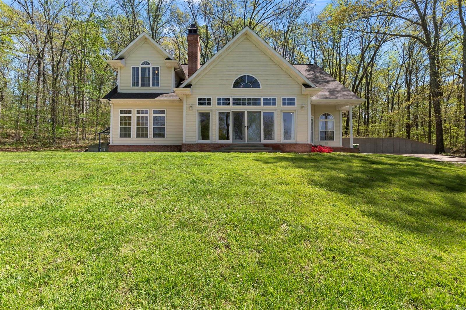 This one checks all the boxes! 4 bdrm, 3 ba, vaulted clng, open floor plan dream is unique in the BEST ways.  6.2 +/- acres. An additional lot with a project mobile home has separate utilities for future income producing potential! Main level master suite with laundry connected to the walk-in closet. See-through fireplace with an antique tigerwood surround from the late 1800s! Large pic windows for viewing sunsets & wildlife. Antique wood floors, doors, & hdwe. 2nd level jack & jill ba + additional laundry. 3 bdrms on the 2nd level + bonus rm used as a kitchenette. 3rd floor bonus rm. 2 large outdoor patios. Imagine sitting in your hot tub on your private back patio overlooking the horizon at sunset. This peaceful slice of paradise is strategically placed between I55, & P&G. The large barn has water & electric to store your boat, utv, with space for other toys. The kids can play outside all while being supervised from within the house courtesy of the majestic bank of front windows.