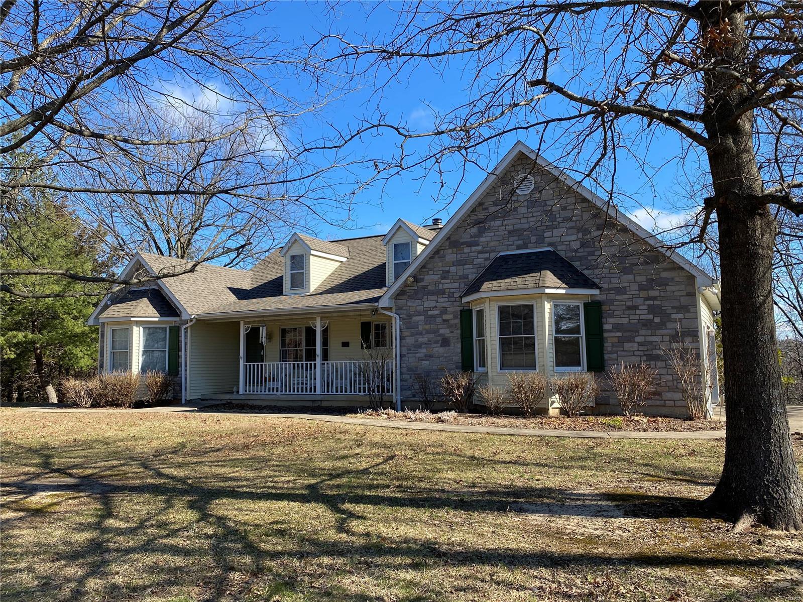 Beautiful 3 bedroom country home with acreage in Hermann! Happiness is your immediate feeling every time you enter this home! The bright, radiant dining/living room with vaulted ceilings greets you as you walk through the front door. The wood burning fireplace offers you a cozy atmosphere in the colder months while the large windows on the back of the home gives you the sense of being submerged nature. Deer and other wildlife can be seen from the deck regularly. 3 bedrooms, kitchen and a delightful sun room also add the same bliss as the rest of the main level. The lower level of the home consists of a spacious open area perfect for a recreation area, family room or partition off space for additional bedroom or office! Also in the lower level you have another full bath and unfinished space for plenty of storage. This wonderful home is located on approx 20 acres mostly wooded except for the large open yard. Also perfect entertaining around the patio & pergola! Call today for showing!! Additional Rooms: Sun Room
