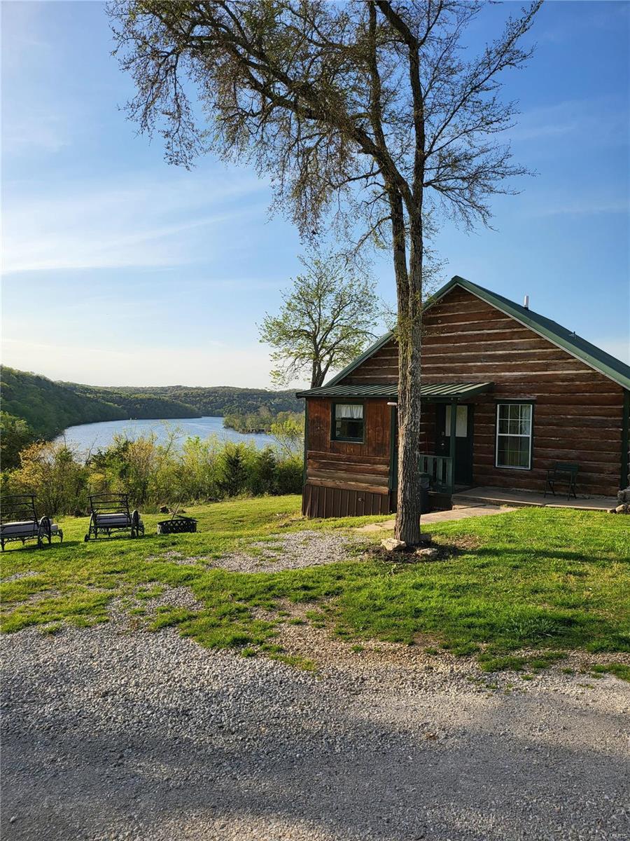 Perched high above Lake Taneycomo, one of the top world class trout fishing destinations in the country, sits Peninsula Cabin & RV Park on 18 acres m/l of the Ozark Mountains.  Located minutes from the Branson Landing, premier golfing, tourism attractions and multiple Johnny Morris Bass Pro developments, sits 3 renovated 1-2 bedroom rustic cabins with kitchens and covered porches with incredible panoramic lake views, a duplex, 3 additional cabins ready to renovate, 13 RV sites with 50/30/20 FHU with room for expansion, laundry and office complex. Bring your boat for the Rainbow Trout, Brown Trout, Largemouth Bass, Cutthroat Trout to the private dock with 2 boat slips, kayaking, hiking and more!  Solar panels provide approximately 50-60% of the power supply, private well.  Possibilities are limitless on this secluded, peaceful lake front 3 sided peninsula property.  Retire here while your investment works for you.  P&L's available, partial owner finance available to qualified buyers. Location: Rural