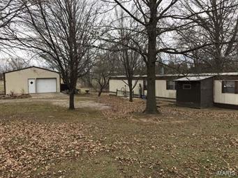 Quiet setting on 1.233 acres out in Silex area-  2 bedroom 1 bath manufactured home with outbuilding. Great investment property with a lot of potential!