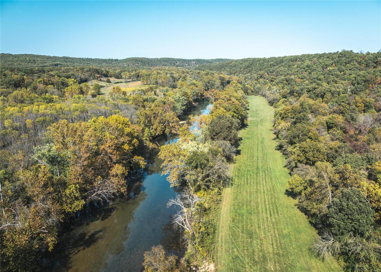 This stunning 75-acre property offers over half a mile of Big Piney River frontage, renowned for its excellent smallmouth bass Fishing. The land boasts beautiful rock formations, a spring-fed creek, and numerous ideal building sites. Perfect for outdoor enthusiasts the property provides county road frontage and is home to a well-maintained trail system, offering easy access throughout. A quarter-mile below Boiling Springs, which produces 12 million gallons of water daily, the property also features a half-mile long river bottom field, currently used for food plots but ideal for hay or pasture. The excellent hunting opportunities for deer and turkey make this land a dream for sportsmen and nature lovers alike.
