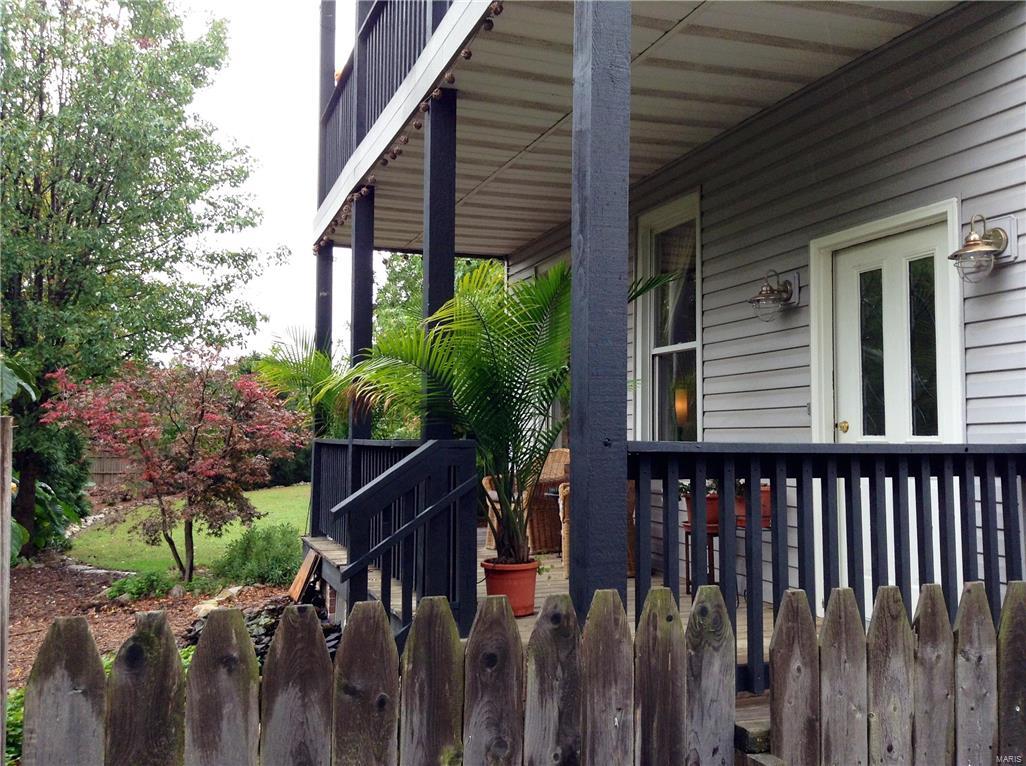 Extraordinary and unique South city property for sale only the second time in over 100 years. Tranquil 1/2 acre city property with updated antebellum farmhouse.  Fully-fenced, park-like backyard, four garages, oodles of off street parking, plus numerous outbuildings for storage and workshops.  Very gracious but unassuming home.  Fully reworked from bottom to top in 1991, and well cared for.  Full bath (shower) and laundry room on the first floor.  Full bath and wee half bath on second floor.  Not likely a fancy place to begin with, it is now utterly bereft of historical detail other than the original banister and the height of the ceilings.  Current owners have eliminated all the carpeting and created durable, cleanable floors throughout.  Excellent location for commuting within the city, or for scooting north or south on 55 or out 44. Make this urban retreat yours!  A HWA home warranty will be provided for the buyer.