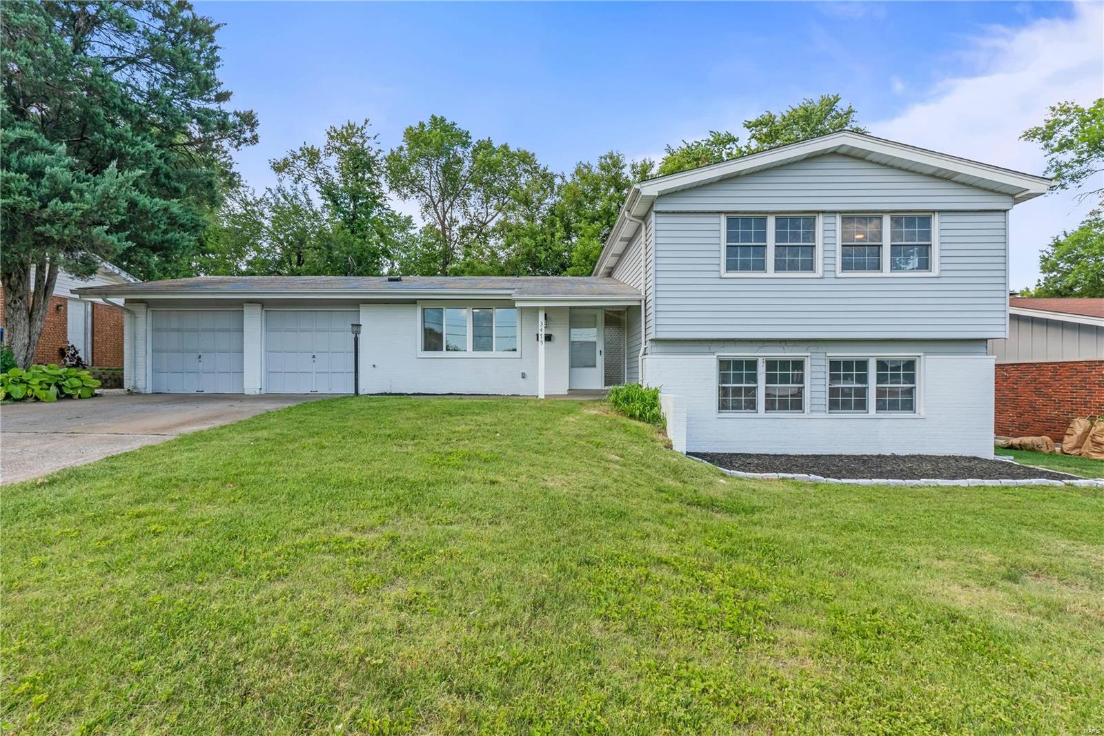 Get ready to be wowed by this stunningly updated tri-level home right across from All Saints Academy! With 1700 SF of living space and a 2-car garage, this place has it all! As soon as you step inside from the garage, the newly renovated kitchen will catch your eye with its beautiful Oak Waypoint cabinetry, SS appliances, white pixie backsplash, & dazzling quartz countertops. The vinyl plank flooring throughout the ML is a showstopper! The living room is flooded with natural light from the sliding doors that lead you to the deck and backyard. Upstairs you'll find a fully updated hall bath and a luxurious primary suite with a brand new bathroom and ample closet space. Two more cozy bedrooms are down the hall. The LL offers a new full bath, large family room, & extra space for a bedroom/office. Don't miss out on the chance to make this beautiful home yours!