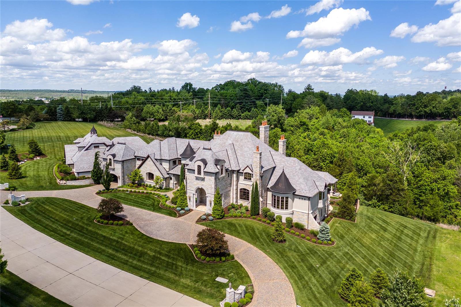 Luxury Redefined, this 16,500 sqft European estate meticulously crafted by Architect Dave Schaub & Builder Mike Bozich, rests on 6 beautifully landscaped acres backing to woods. Every inch custom curated, this exquisite home leaves nothing to be desired. Intricate wall/ceiling mouldings, extensive cabinetry, crystal chandeliers & Venetian plaster. Experience majestic & jaw-dropping elevations w/floor-to-ceiling millwork in 2Sty Foyer & Grand Salon. Hearth Room & Study warmly decorated w/wood beams & hand-painted cabinetry. Kitchens, Grand Salon Bar & Dining Room are impeccably designed for large gatherings. Master Wing offers luxury & privacy w/balcony terrace. En Suite Beds, Bunk Room, Game Room, Lounge & Kitchenette upstairs. Entertainers dream in LL with Bowling lanes, Theatre, Rec Room, Fitness & Sauna. Enjoy a covered veranda, saltwater pool w/swim-up bar, tanning ledge, stone spa, waterfalls & fire features, pool house, 2 outdoor kitchens. Gym w/sport court & add’l garage space.