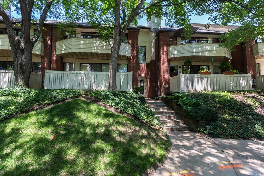 A lifestyle that offers the best of both worlds - walk to Forest Park & Metro Station plus a quick commute to the vibrancy of the CWE and The Loop - this 3 bedroom and 2 full bathroom condo is a gem. The open design living & dining room with vaulted ceiling & wood burning fireplace is warm & inviting. A wall of windows & sliding door opens to a private balcony - perfect for outdoor enjoyment & entertaining. The eat-in kitchen has abundant cabinetry & a custom built-in breakfast area. Two well sized bedrooms, full bathroom & main level laundry completes this floor. The master suite, on the 2nd floor, w/10 ft ceiling and 2 prof. organized walk-in closets plus an additional bonus storage area & private balcony - is a perfect hideaway. The master bathroom has 2 vanities & a private commode. All the closets feature St. Louis Closet Company custom systems. The 2 car attached garage & storage room completes a lifestyle that is simultaneously comfortable & elegant. Location: City