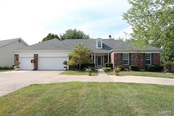 Gorgeous double culdesac on quiet street. Over 2500 sqft on the main level plus approx 1700 sqft in walkout lower level. BEAUTIFUL updated hardwood floors, stylish ceramic tile plus new carpet in July 2015. Fresh paint, upgraded to tall baseboards and trim, switch plates updated to white, light fixtures and fans updated, BEAUTIFUL custom built-ins in great rm, custom plant molding & chair rail in dining rm, new blinds July 2015 in bedrooms. Full brick front, circle driveway, 3 car o/s garage. Large  LEVEL fenced private lot with mature trees. The kitchen offers granite counter tops, upscale stainless steel appliances~dishwasher, wall oven/micro combo, electric cooktop in the center island, dual pantries. Florida rm. Bedrm 2 & 3 were enlarged at the build HUGE- they offer that extra space that buyers are searching for. Luxury master suite. Outstanding finished lower level with Fam rm, 2 bedrms, a wetbar, 2 bonus rms & full bath. Subdivison pool & cabanna.  GREAT home - must see!