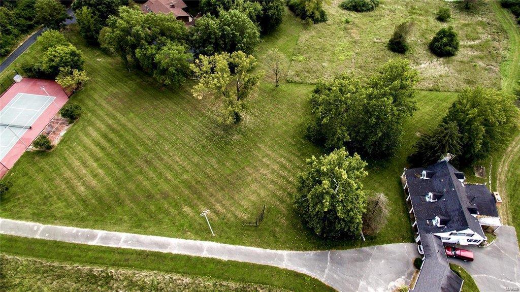 A BEAUTIFUL PIECE OF LAND IN A PREMIUM LOCATION! This exclusive 13-acre property is located on a private drive off Clayton Road and in the heart of the Town & Country neighborhood. You will be within walking distance to the new T&C Town Square, close to Queeny Park, Downtown Clayton, Washington University, Lambert International Airport & more! The property includes a full-sized lighted tennis court, 3 stall horse barn, hayloft, and toolshed. It is perfect for the equestrian-loving family, farmers, or someone looking to experience all that St. Louis has to offer but in countryside tranquility. Offers an elevated scenic view with peace, safety, and privacy in St. Louis County. There is plenty of space for a full-size soccer field, horse arena, carriage house, swimming pool,
and garden. The existing home can be the site of your dream estate. The land is not available to be subdivided and is sold AS-IS. This is a once-in-a-lifetime opportunity that you have only dreamed about!
