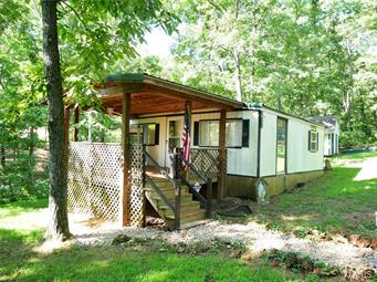 Great weekend getaway! This two bedroom, lake view home offers a large covered deck, central HVAC system, metal roof and a large storage building with workshop. This property is located two lots, only steps away from Lake Wahoo.