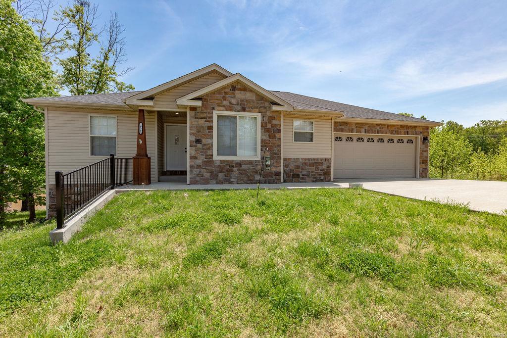 This meticulously maintained home is located minutes from many shopping and dining options and the main gate of Fort Leonard Wood. The gorgeous solid flooring in the kitchen and dining area perfectly complements the custom kitchen cabinetry, countertop, tile accent and stainless-steel appliances. The living room opens to a deck overlooking the spacious back yard surrounded by a privacy fence, ideal for gatherings of family and friends. The master bedroom features a recessed ceiling with accent lighting and a beautiful master bathroom complete with double sinks, tiled walk-in shower and a generous walk-in closet. The lower level has a second living area, a bedroom and full bath while retaining a huge unfinished area for all of your storage needs. Make an appointment for a private showing today!
