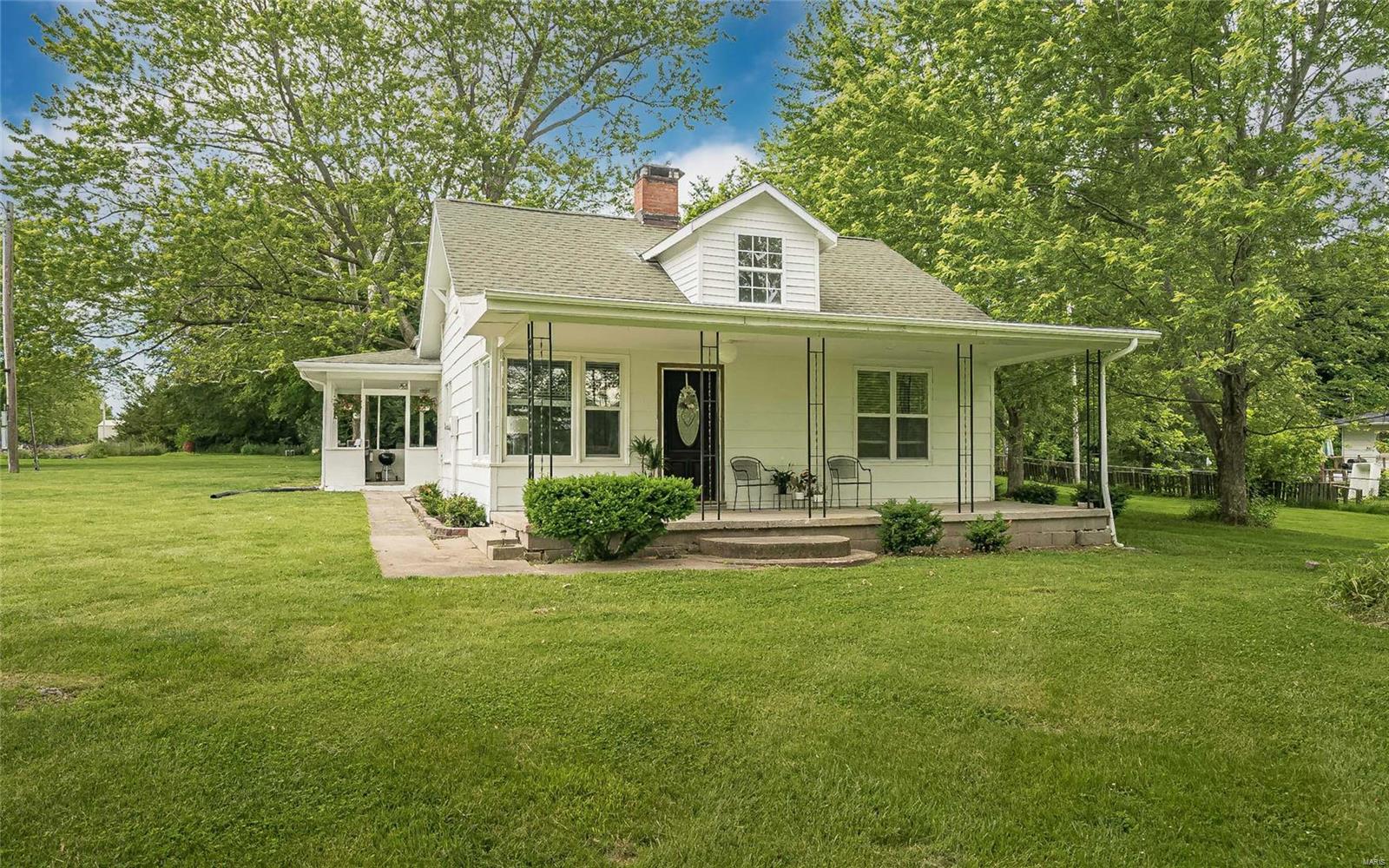 Take a look at this charming, country-style home on 3.3 acres with an OVERSIZED GARAGE/shop! Exterior has been freshly updated to a GORGEOUS farmhouse white! Flooring has been updated throughout with Luxury Vinyl Plank in Living Room and Master Bedroom & Brand New Carpeting on the upper level. Features Main Floor Laundry and an Eat-In Kitchen. Cozy up to the fireplace on those cold winter nights... and enjoy the great outdoor entertaining spaces in the spring, summer and fall under 2 covered porches! Great mix of woods and open land on this property!