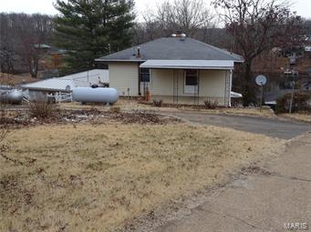 Water Front Home on Beautiful Potosi Lake Village. Here is your chance to own your own Private get away on the Lake. 
This 2 bedroom 1 1/2 Bath home features a huge family room that is 27x14, a nice sized kitchen, and a Peaceful 4 season sunroom with newer tilt in windows that is 27x12 and overlooks the beautiful lake. There is a 20x17 Deck and a floating Dock that is included also. The 2 bedrooms are on the main level with the full bathroom. As you walk into this home you will notice the Newer Carpet and flooring throughout, Tilt in windows, and updated Bath. In the Lower Level is the Kitchen, Family Room, Laundry, Four season sun room, 1/2 bath and storage area. The two car detached Garage sets across from the house on its own lot that is 48x135x49x127. The home itself is on a lot of 47x187x57x187. So you get two lots with this property. Two Tax numbers included in this sale.
20-8.0-034-001-001-037.000 and 20-8.0-034-001-002-039.000. Additional Rooms: Sun Room