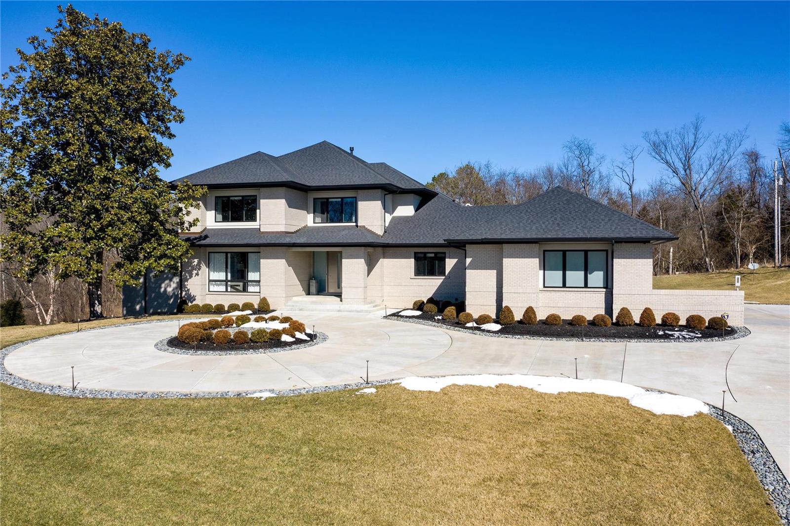 Set on over an acre, this home has every state-of-the-art amenity imaginable. It was built to the highest standards, including tall ceilings, wide plank white oak floors, designer lighting, & high-end appliances. The perfect balance of formal entertaining space is offset by casual high-end living spaces. Accommodations include 5 bedrooms, 8 bathrooms, formal dining rm, several living rms, a lower level theatre rm, separate full kitchen, & gym. Professional chefs' kitchen with sleek, modern cabinetry, top of the line appliances & 2 islands w/ beautiful Quartz stone waterfall island. The luxurious Master Suite situated on the main floor comes second to none with impressive views & spacious custom closet. Spa-like ensuite boasts modern vanity, free-standing tub, & large shower. On the upper level, you will find 3 ensuite bedrooms, with walk-in closets & separate laundry area. The expansive outdoor area is the perfect backdrop for a pool/spa oasis & backs to trees for ultimate privacy.