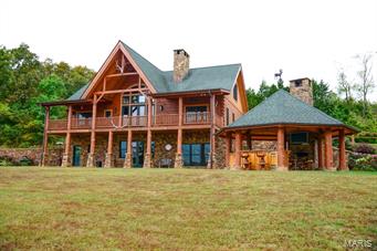 Turnkey Lodge or Retreat, Mark Twain Forest between Sullivan, Steelville & Potosi. Log lodge; no expense spared, wood and stone throughout, 7 grand rooms, 3 BR, 4 1/2 BA, outdoor kitchen/bar, patio, deck, great views. Backup generator, buried propane tanks. Guest Log Cabin; 5 rooms, Master BR, 2 sleeping areas in the loft, 1 ½ BA, kitchen, laundry and porch. Food plots, deer stands, feeders and native grass stands. Secluded, bordered by large tracts, great deer and turkey. Year round spring, stocked pond can hold trout, mile of Fourche Renault and Ebo Creek frontage, excellent smallmouth bass and fly-fishing. Nearby Meramec Springs and Meremac River for trout fishing and floating. 4 outbuildings and fuel tanks. Skeet/Trap range is over the top. Rifle range; targets out to 495 yards, covered bench. Price includes custom furnishing, accessories, appliances, utensils, linens, tractor, implements and equipment. Appointment only, qualified buyers.