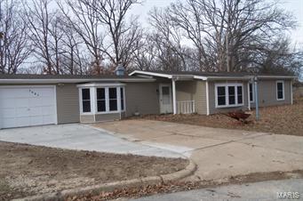 Several updates: newer siding, windows, kitchen with some  stainless appliance, some newer floor.   Woodburning fireplace to help heat the home.  Lovely kitchen with plenty of countertops. Large family room has a bay window.   Seller offering a one year Home Warranty   Family room has a base board heater and window a/c.