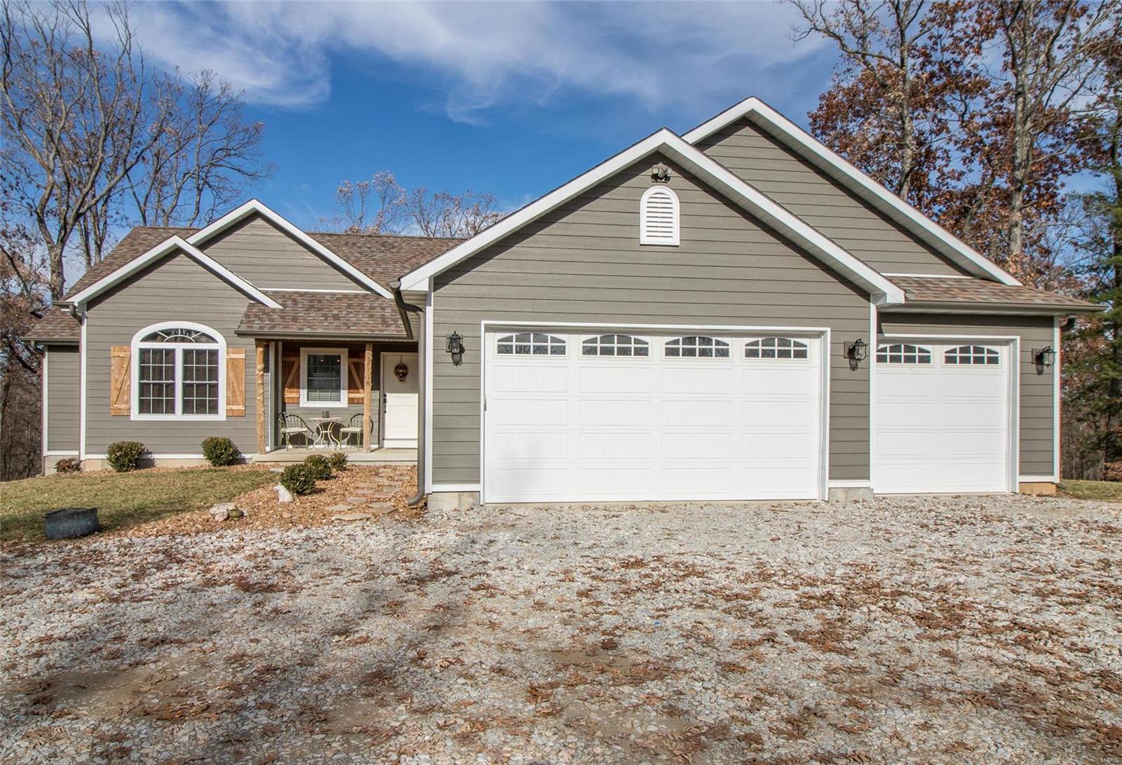 This 3 bed 3 bath CUSTOM ranch home on 5 ACRES with a 3 car over sized garage offers an open floor plan with vaulted ceilings, wood floor throughout, and a cozy rustic charm.  The kitchen is sure to impress with custom maple cabinetry, farm house sink, and butcher block counter tops with large breakfast bar. The fireplace insert is wood burning and can efficiently provide an excellent heat source in addition to standard furnace.  This custom home has upgrades galore,LP Smart siding, walk out basement ready for your finishing touches w/ 9 ft pour, tornado shelter room, 2 electrical panels, water softner, rough in for bath. The lower level could easily offer the space for 2 more bedrooms!  The master suite is spacious w/ vaulted ceilings, master bath has an enormous open concept shower and separate tub. The split bedroom floor plan has jack and jill bath, and 10 ft ceilings, custom mouldings, solid wood 2 panel doors throughout, a separate powder room, main floor laundry/ mud room.
