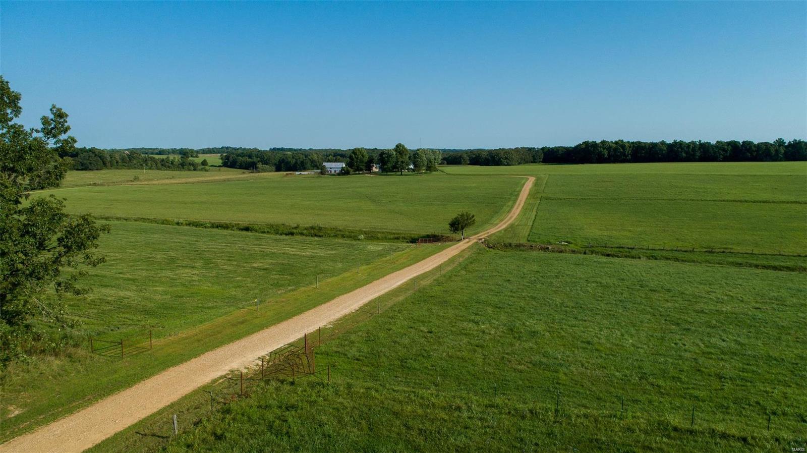 Missouri Century Farm with approximately 120 acres in the heart of Gasconade County. Original log home has been well maintained by the family for generations. Main residence hosts 4 bedrooms, 2 baths & an open concept dining/living area. Large kitchen has some of the original logs exposed & wood floors to enjoy. Majority of acreage is open, fenced/cross fenced and includes 4 energy free watering systems. Two stocked ponds & a wet weather creek are great for recreation, fishing & hunting! 36x52 shop is predominately finished, heated and insulated with one overhead garage door & one sliding door. Oversized detached garage, barn, pole barn, quonset hut and a storage shed.  Separate guest house/hunting cabin with an open concept design has a kitchenette, bedroom & a full bath. Secluded from roads & traffic but only minutes from conveniences. Agent owned & priced under recent appraisal!