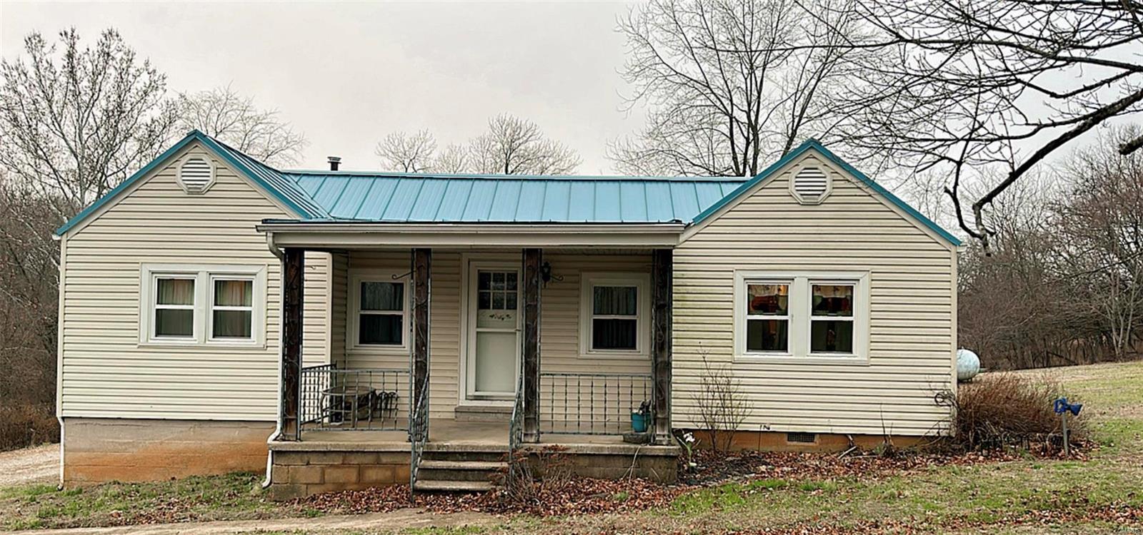 Just right outside of town this 2 bedroom 1 bath home sits directly in the middle of just under an acre. The home has a brand new metal seamless roof,  double hung windows, newer HVAC, completely replumbed with pex, newer hot water heater, along with a complete bathroom remodel. Pristine original hardwood floors in the home!