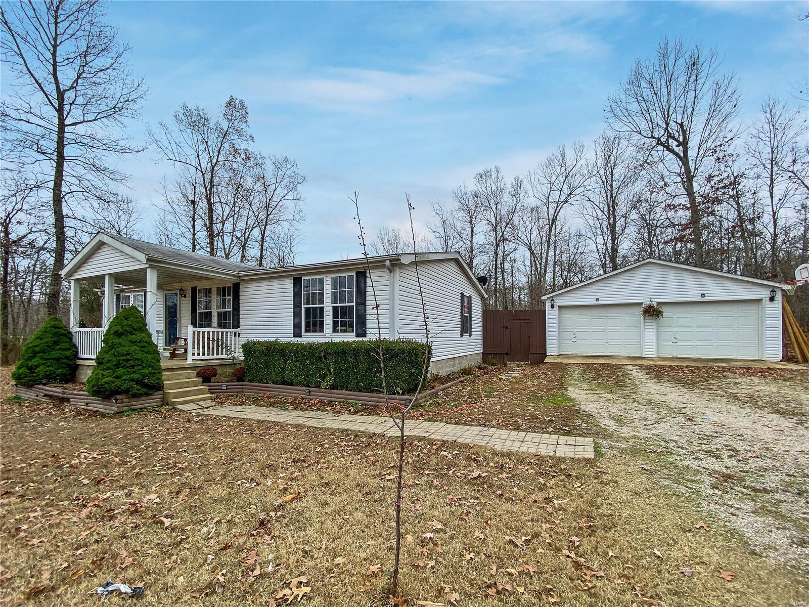 Neat and clean, 1999 manufactured home sitting on 6.5 acres.  3 bedroom, 2 bath with vaulted ceiling, master suite with walk in closet, garden tub, shower, double vanity.  Outside is detached 24x20 garage, fenced in back yard.