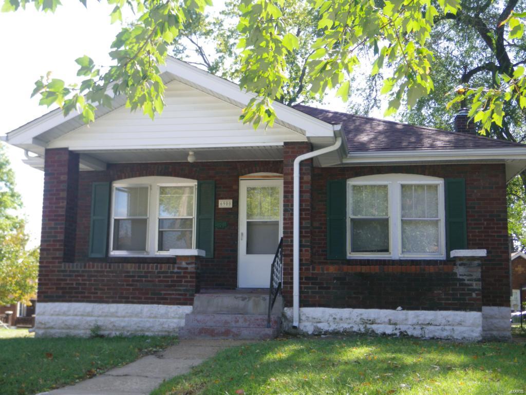 Great 2 BR home with lots of potential for buyers' own personal touches. Home boasts a covered front porch, NEWer roof, enclosed soffits, Living Room/Dining Room combo, KIT, 2 bedrooms & good-size basement. The living room fireplace adds a cozy touch! The tucked garage was converted to additional basement space for larger basement but could be converted back by adding walls. Corner lot runs from one street to the other. No neighbors in back or on one side.  Close to major highways, shopping, and public transportation. Great house for an investor or someone willing to put in a little TLC. AS IS condition, but in decent shape.