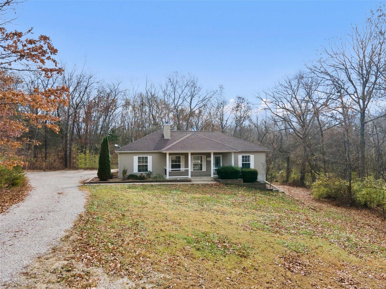 Nestled on 3 acres of woods, this lovely ranch has a BRAND NEW (2021) roof & heat pump + recently updated water heater & water softener! Efficient & reliable cell phone & Starlink internet connectivity. Tall 9' ceilings, durable laminate floors, brick fireplace & an open floorplan in the main living area. Dining room slider opens to the multi-level composite deck overlooking the trees. Breakfast bar, SS appliances & tile backsplash in the kitchen. Tucked in its own nook is the primary suite w/private bath & walk-in closet. In the opposite wing are 2 spacious family bedrooms & full bath. 2 additional bedrooms in the finished lower level + a nicely updated full bath w/impressive tile work, & 3 bonus rooms perfect for a home office, gym or playroom! Public water & HOA-maintained streets. Graded/rocked driveway (2021). Super easy access to I-70 & amenities, like Cedar Lake Cellars for dining & live music! 13-mo home warranty included. Wright City Schools. Secluded paradise! See it today!