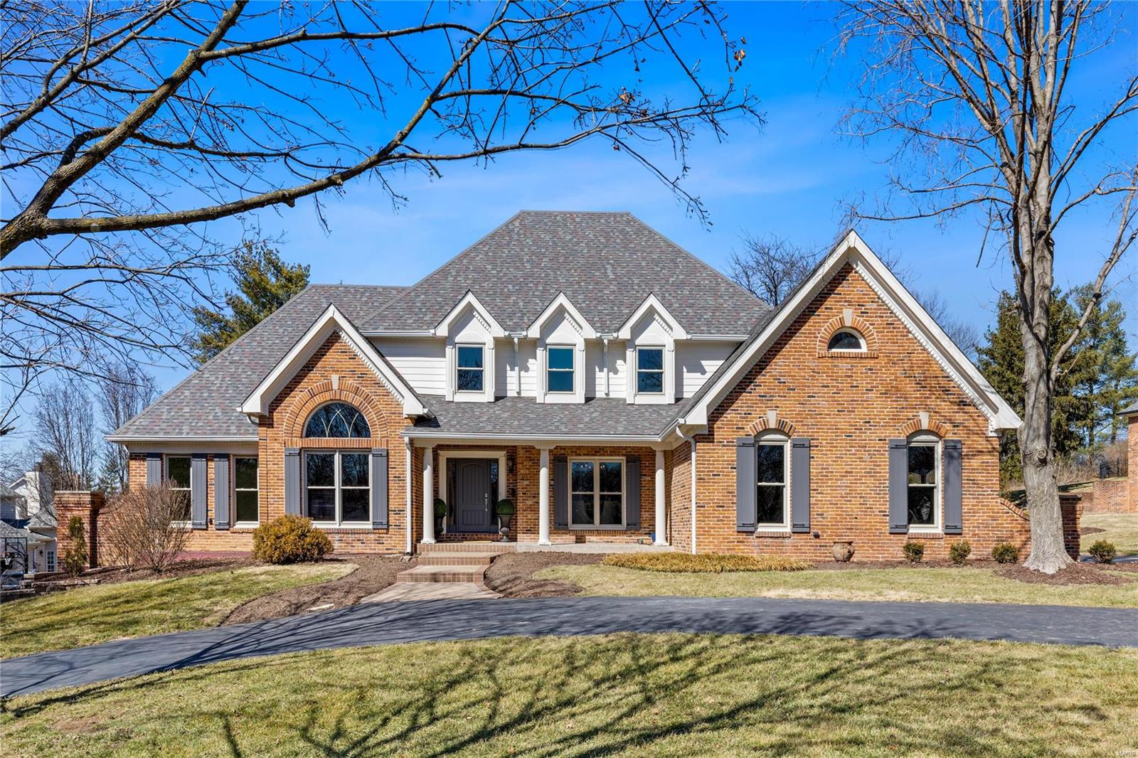 This spectacular DeShetler-built 1.5 Sty features soaring ceilings, detailed trim work, plantation shutters & oak hardwoods that extend throughout the main living area. Impressive 2-sty foyer leads to well-appointed study surrounded by natural wood paneling & built-in bookcases, formal dining room and stunning great room with beamed cathedral ceiling, brick fireplace, skylights & atrium door to patio. Designer kitchen with quartz countertops, 42” cabinetry, premium appliances & 8’ center island adjoins hearth room with octagonal ceiling & floor-to-ceiling stacked stone fireplace. Spacious primary bedroom suite with luxury bath with shower spa & soaking tub offers an appealing retreat. T-staircase accesses 3 additional bedrooms, 1 with ensuite bath & 2 with Jack n’ Jill bath, & sitting area. Walk-out Lower Level includes recreation room with wet bar, family room with fireplace, game room, hobby room & full bath. Situated on parklike 1+ acre grounds with deck, 2 patios & 3-car garage.