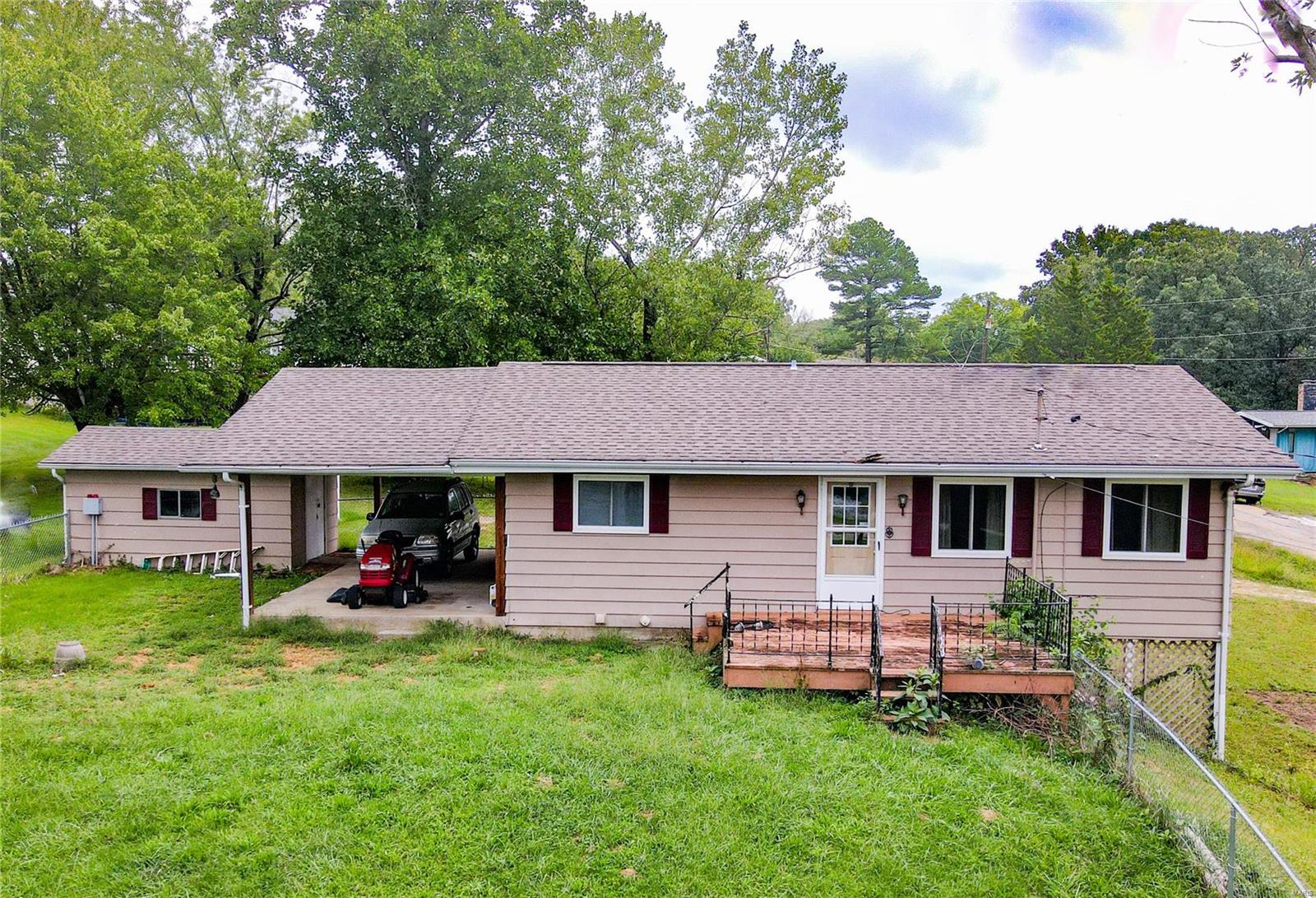 This three bedroom lake view home is priced to sell. Located on a double lot with fenced front yard, within walking distance to the lake. This property also features, updated windows, newer roof, full walk-out basement and a carport.