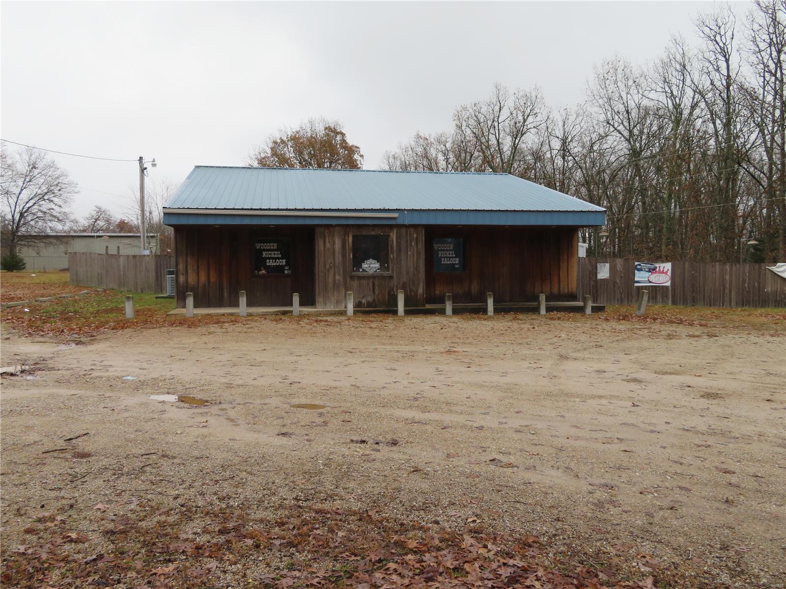 THIS IS A STEAL!  The perfect location for a business venture!  Half way between Dixon and St. Robert in a centralized area.  Building includes many items to help start a bar and grill, which is what it was previously used for.  Inside includes a huge open area with a bar and stage, there are also 2 bathrooms, a mop closet, kitchen, and walk-in cooler.  This building also includes an office space and an attic that could be an office or storage space, with a potential bathroom, above the bar.  Also included are: coolers, inside and outside tables and chairs, televisions, POS system, plates and utensils, pool tables, pool sticks, etc.  Outside has a fenced in area with 2 sheds, huge pavilion, a covered stage, and a spot for an outside bar.  The lot has at least 30 parking spaces, with potential for more.  There are also two other storage buildings located by the parking lot.  GREAT PRICE FOR ALL YOU'RE GETTING! SpecialListingConditions: Foreclosure Location: Hwy/Interstate Frntg