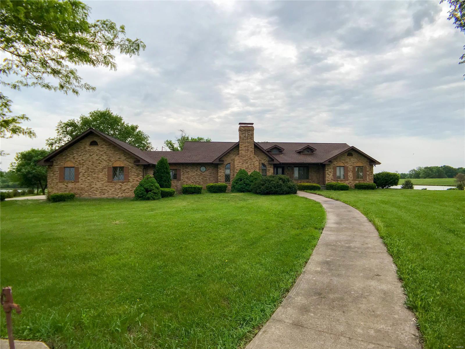 True craftsmanship is an understatement, this 2X6 construction walkout ranch has approx. 6000 finished sq. ft. w/ Chicago style brick and big coin corners, herringbone and archway patterns, Anderson casement windows (bays & bows), an oversized 3 car garage w/ side entry, & a brand new roof. Property consists of 80+/- acres of mostly gentle rolling pasture/hay with approx. 5 to 6 acres of timber. There are 3 beautiful lakes: approx. 5, 1.5 and 1 acre in size as well as 3 fenced ponds with drinking troughs for livestock.  Approx. 60 acres is fenced and cross fenced & ready for livestock. A metal barn w/ electric service allows for storage of equipment. This property has almost ½ mile of frontage on Hwy 154, located just west of the South Fork boat ramp, making the property ideal for starting a boat/RV storage, or B&B/RV park. Property is to be sold as is. With an easy drive from STL/Chicago/KC, escape to this private country estate!