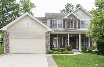 Beautiful 12 yr old home with 3 CAR TANDEM GARAGE! Open floor plan, 9 foot ceilings on main floor. Gorgeous wood floors through the foyer, kitchen and breakfast room. Family room with built in bookshelves flanking the gas fireplace and 5-bay window. Gourmet kitchen with 42 inch cabinets, granite counters, tile back splash, large island with pot rack above, black appliances including a newer dishwasher, pantry, and breakfast room bay window. Half bath with tile floor. Upstairs are 4 large bedrooms including a master bedroom suite with walk in closet leading straight into the 2ND FLOOR LAUNDRY ROOM! Master bath with separate tub/shower, dual sinks, additional full bath off the hall. FINISHED LOWER LEVEL with large rec room featuring a wet bar and full bath. Additional features include ZONED HVAC, central vacuum system, newer carpeting. Private back yard nicely landscaped with patio and pergola. Great street with lots of children playing, walk to Twin Oaks park, and close to highways!