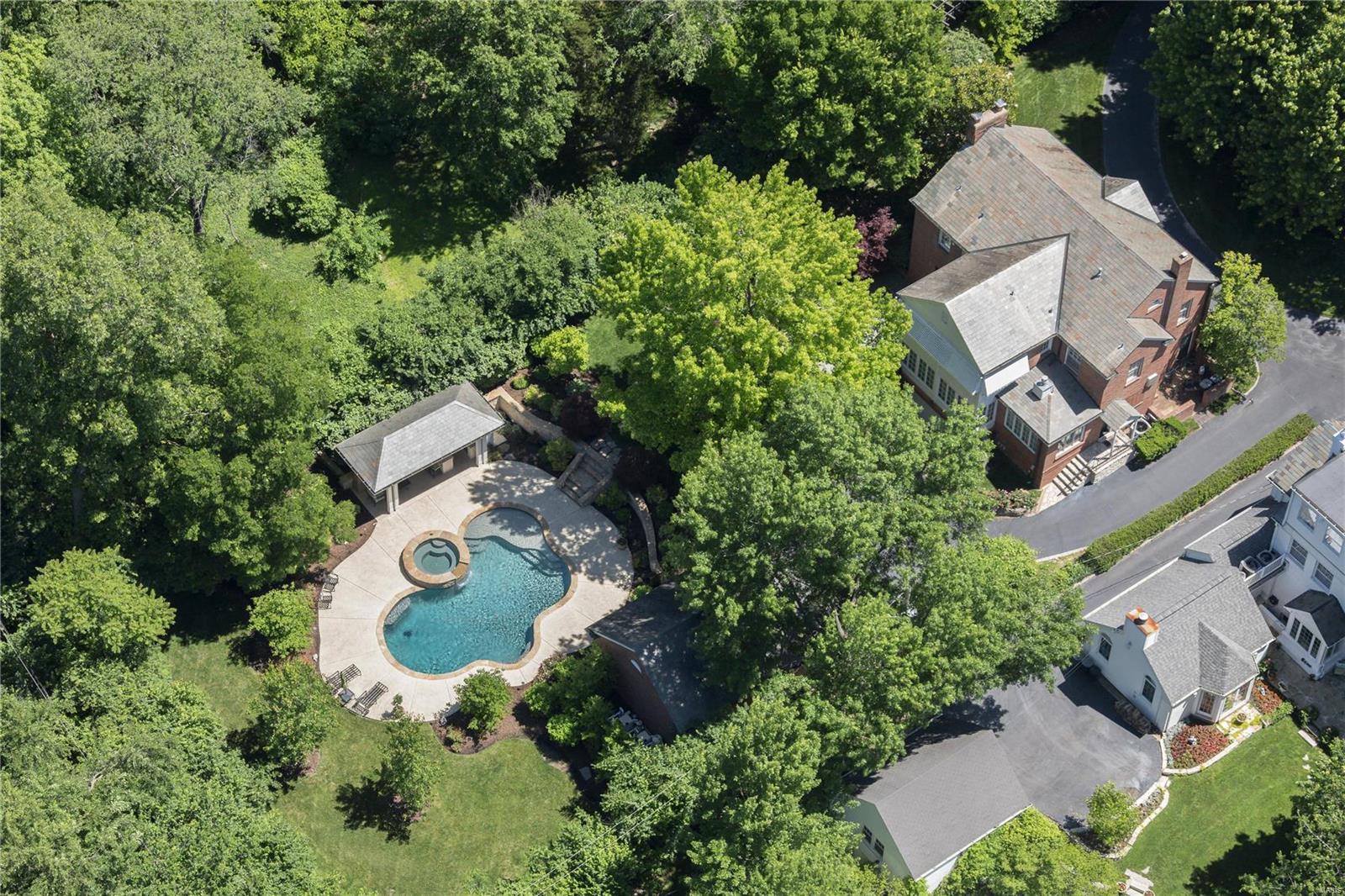 Improved price makes this timeless classic the strongest buy. Understated and elegant; in the prominent Fair Oaks subdivision. #21 is extensively renovated and improved with $900,000 of improvements, with a new kitchen, breakfast room and hearth room addition, gunite pool, spa, pool house, outdoor kitchen, lush private landscaping, decks and patios. There is a new oversized detached garage, providing parking for 4 total vehicles, and extensive waterproofing and drainage systems. Wolf and SubZero appliances, marble & granite counters, island, organized pantry, refrigerated beverage drawers and wine cooler, for a flawless kitchen and gathering place. Second level primary suite with spa inspired bath, outfitted in  Carrera marble. New HVAC systems, Marvin windows, surround sound, security and central vac systems. Four bedrooms and office on the 2nd level. Lower level billiard and media rooms, with extensive built-ins. Slate roof on the main house, garage and pool house. Simply perfect.