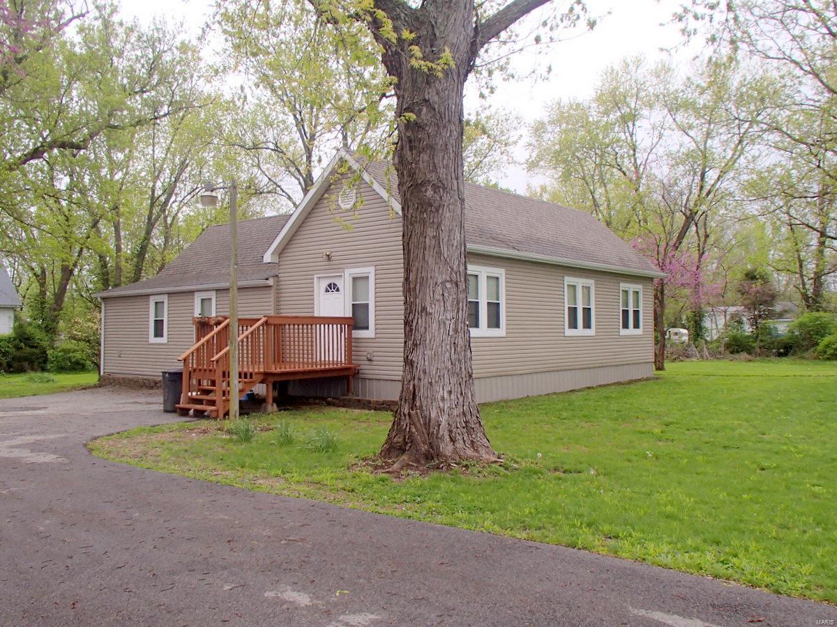Renovated home on three lots measuring 50 x 150 for a total lot size of just over 1/2 acre. Renovations completed since 2009 include  installation of insulated double hung windows, six panel doors, laminate flooring, 30 year architectural roofing, 200 amp electrical service panel box, updated HVAC and more! Family room, dining room, & kitchen area are open to each other which allows one to expand a preferrd room into the other. Hallway area that leads to bedrooms could easily accomodate a sitting or study area if one wishes. Includes two small outbuildings in rear yard and plenty of room to build a sizeable garage if desired.