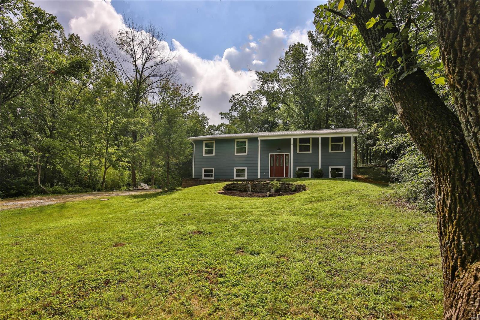 Completely remodeled split-level home with a 2-car tuck under style garage! This home is absolutely beautiful with new flooring throughout, newly painted neutral walls and new updated light fixtures. The dining area has sliding glass doors that lead to a deck that is perfect for entertaining guests or just relaxing & enjoying the view with so much privacy from the wooded surroundings. Kitchen has new cabinets with plenty of storage space, gorgeous granite countertops, stainless steel appliances and butcher block topped center island with breakfast bar. The main level has a large master bedroom that includes a master bathroom with shower only. Also on the main level are two other ample sized bedrooms and full bathroom. Downstairs there is another spacious bedroom that has a bathroom with shower only and double sink. Everything has been done immaculately throughout this home which makes this home move in ready!
