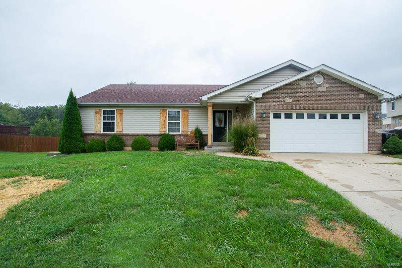 This incredible 3 bed 2 full bath ranch with an open vaulted floor has been remodeled with custom finishes and is a delight to show!  Newer laminate flooring throughout-The living room has a vaulted ceiling, electric insert fireplace with remote and wood mantel plus custom wood hearth. Kitchen is nicely finished with custom cabinets, subway tile backsplash with detailed ceramic tile insert above cooktop, granite countertops, custom vent hood, pantry and large center island with seating-Additional kitchen space includes floating shelves and coffee bar area. Master bedroom suite, two additional bedrooms and full hall bathroom finish out the main floor. Access to the covered patio and fully fenced backyard off the eat in kitchen is great for entertaining plus has nice shed with garage door-This home also offers main floor laundry, a two car garage and an unfinished basement with rough in to finish to suit your needs or for plenty of storage space.