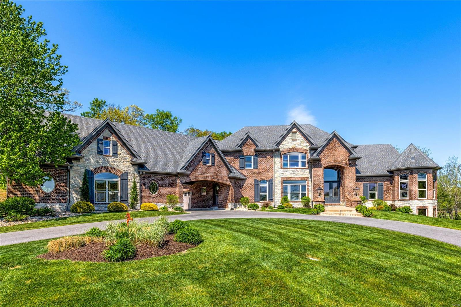 Extensively renovated full-brick Estate home from award-winning Cross Homes. Impressive 2-sty hardwood foyer leads to elegant dining room and stunning great room with dramatic bow window, box beam ceiling & direct vent fireplace flanked by built-in bookcases. Designer kitchen with 42” cabinetry, quartz countertops, Viking appliances, 12’ center island & butler’s pantry adjoins breakfast room & step-up hearth room with floor-to-ceiling stacked stone fireplace. Coffered primary bedroom suite radiates warmth with a linear gas fireplace, sitting room & beautifully appointed bath with walk-through shower spa & jetted tub. Open staircase accesses 3 additional ensuite bedrooms & vaulted bonus room. Lower Level includes recreation room with brick & stone fireplace & wet bar, game room, guest suite & ½ bath. Situated on a wooded 4.12 acre lot with outdoor living room with full-height fireplace, grilling station, hot tub patio & gunite pool plus 6 -car garage, porte cochere & auto court. Additional Rooms: Mud Room