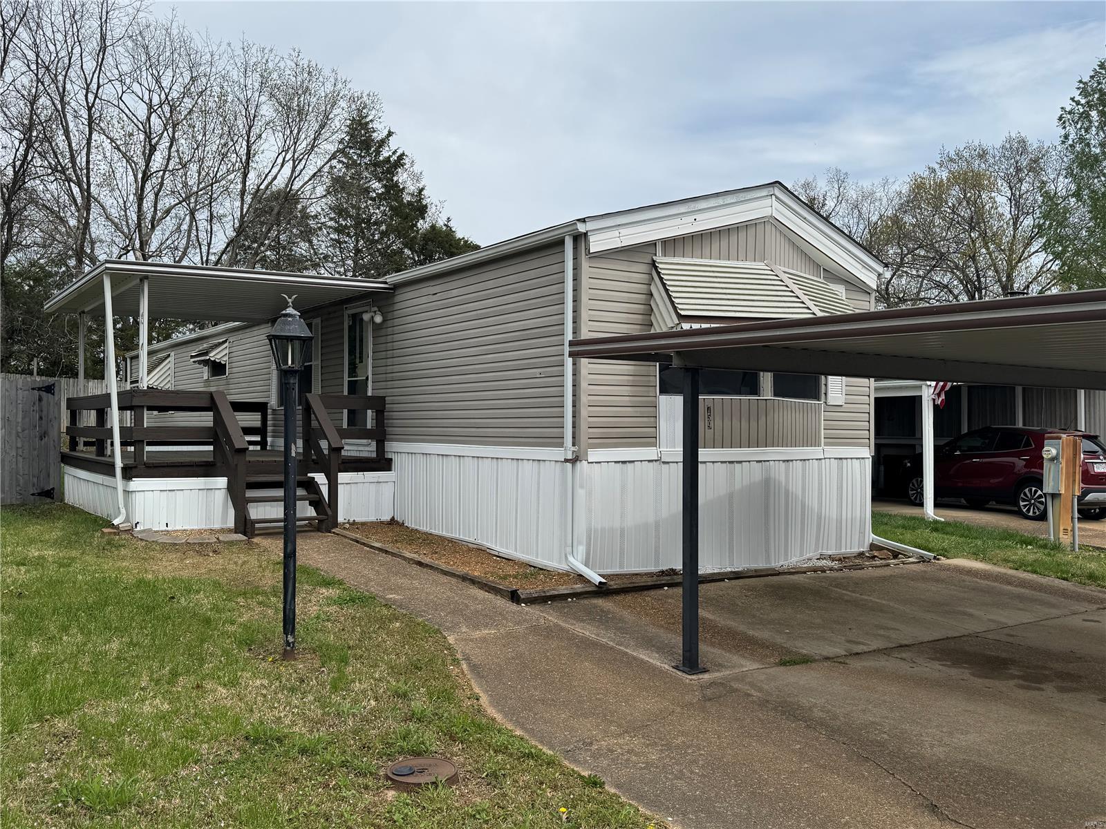 Charming 2-Bed, 1.5-Bath Mobile Home on Private Land – Fenton, MO

Looking for affordable homeownership with land of your own? This well-maintained 1987 Zimmer Mobile Home is situated on a private lot on a quiet cul-de-sac in desirable Jefferson County – no lot rent and no park restrictions!

Features brand-new flooring throughout, a bright and spacious layout, and recent upgrades including newer siding, a new refrigerator and stove, and central HVAC for year-round comfort. The home features a cozy living area that opens to a covered deck – perfect for relaxing or entertaining.

Outside, enjoy the privacy of a fenced-in yard, a handy storage shed, and a carport to keep your vehicle protected from the elements.

The mobile home title was surrendered to Jefferson County in order to affix the home to the land (No Personal Property Tax)

Schedule your showing today – homes with land at this price point don’t last long!