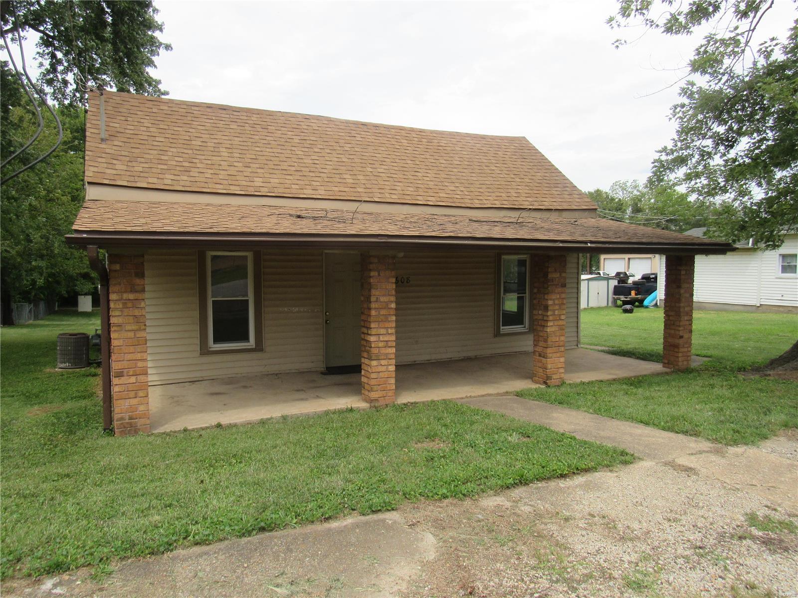 CUTE Home with Several Updates! NEW Carpet in Living Room & Bedrooms, Newer Windows, Vinyl Siding & Freshly Painted! 2 Good Sized Bedrooms, Central Heat & Air, & Extra Large Backyard for Family Fun!