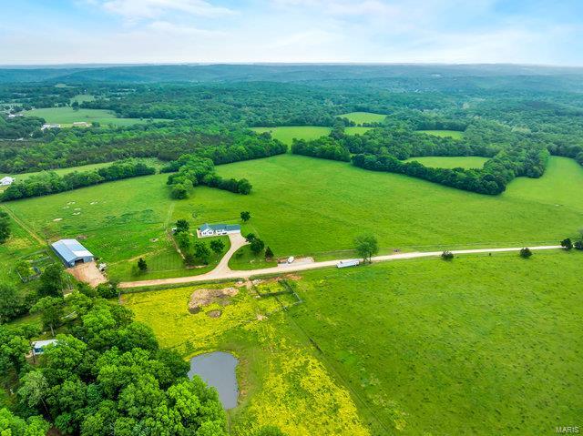 Beautiful rolling pastures in each direction, mountains off in the distance, long lines of fences & cross fences, a working cattle operation on 110 ACRES of stunning pastures and timber. The deer, turkey & other wildlife surround you! You'll love the completely updated ranch home with 1800SF+ of main floor living & another 1800SF+ of finished w/out lower-level space! Beautifully finished w/hardwood floors, custom cabinetry, kitchen w/farmhouse sink, gas stove, wall oven & microwave, master suite w/soaking tub, shower, double vanity & barn doors, two adt bedrooms & full bath, spacious & open family room, kitchen & breakfast room, main flr laundry with 1/2 bath. Walk into LL to find a rec room, 2 adt bedrooms, full bath & storage. This home is constructed with 2x6 walls, insulated windows & truss-type floor joists... 120'x50' Barn chocked full of tractors and other farm equip that is available separately. Keep running cattle (cattle not included), crop farm or use for recreation.