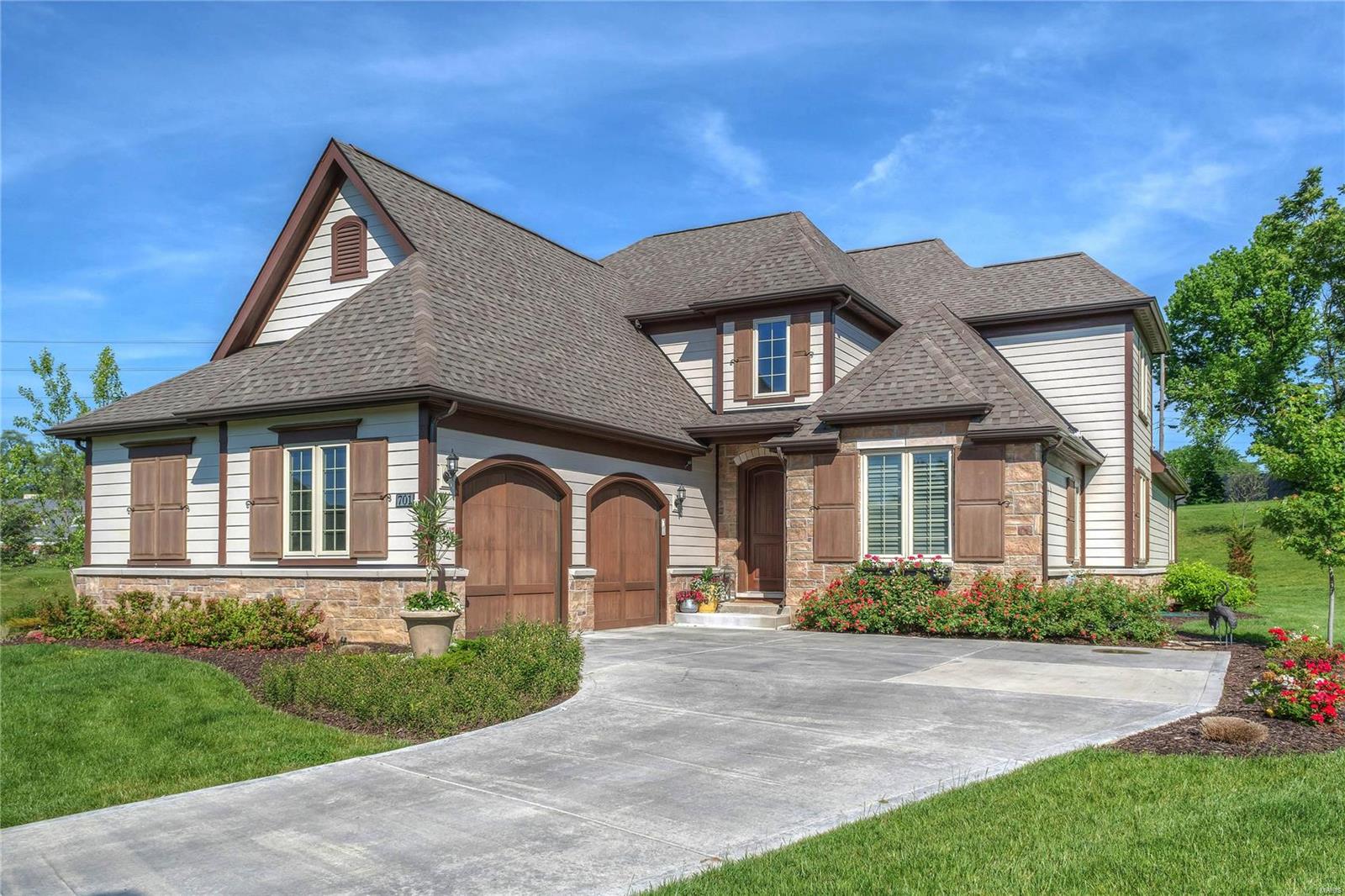 Spectacular 1.5-sty executive home in premier Ladue neighborhood! Open floor plan features extensive millwork, designer finishes & hand-scraped hardwood flooring throughout the 1st & 2nd floors. Impressive 2-sty foyer leads to private study, elegant dining room & stunning great room with wall of windows & floor-to-ceiling stacked stone fireplace. Chef’s kitchen with 42” white cabinetry, granite countertops, KitchenAid appliances, center island, butler’s pantry & convenient planning center adjoins light-filled breakfast room with atrium door to patio. Coffered master bedroom suite provides an appealing retreat with His & Hers walk-in closets & Carrara marble bath. The 2nd floor extends the living quarters with 3 additional bedrooms & hall full bath. Lower Level entertainment space includes recreation room with wet bar & family room plus 5th bedroom & full bath. Situated on a premium cul-de-sac lot with patio & oversized 2-car garage. Upscale living with included landscaping & lawn care. Additional Rooms: Mud Room