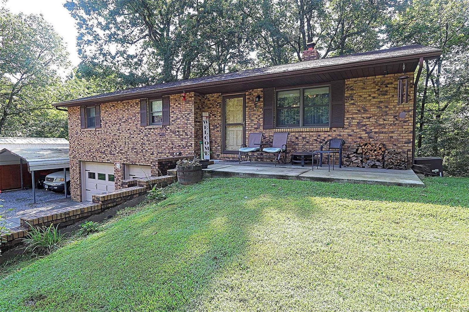 How would you like some elbow room in Cape county. Here is your opportunity with this gorgeous brick home in an awesome wooded setting. You will love retiring daily to this inviting home offering privacy and serenity . Some of the incredible features include wood flooring throughout, living room with beautiful built-ins, a family room with arched doorway and bow window with bench seating. The kitchen has ample cabinetry, stainless appliances, ceramic tile flooring and wainscoting on the dining wall. Master bedroom bathroom offers a jetted tub and quality tile work. The lower level is the place to go for entertaining as it's equipped with a shuffle board game.
There's also a workshop area off the 24' x 26' 2 car garage. Home offers electric forced air heat, but If you prefer wood heat there is a wood furnace as well. Outside there is an awesome deck overlooking the woods, what a great place to relax. Plenty of space to park with the additional carport and driveway area found here.