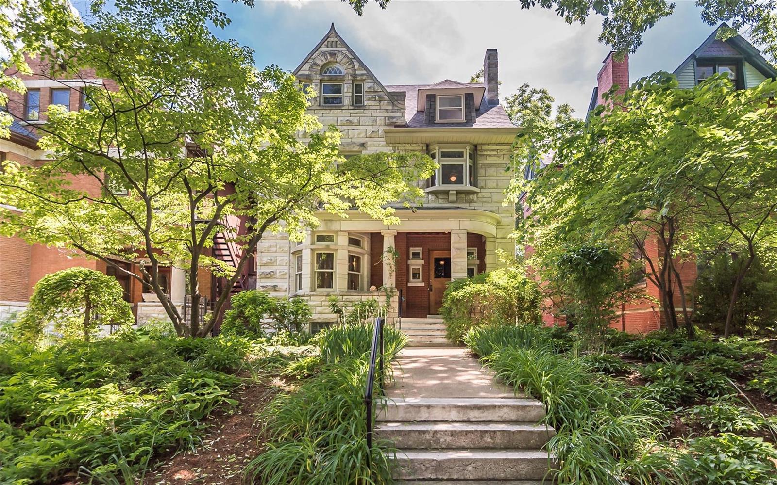 Gorgeous turn of the century stone manse in the heart of the historic Central West End & the new Cortex Development. You're sure to fall in love with the curb appeal of this lovely home nestled on a quiet street. From the minute you step into the foyer you'll be impressed by the beautiful original millwork throughout the first floor, including a fabulous staircase. You will be equally impressed with the large light filled family room at the rear of the home with a wood burning fireplace which opens to a large deck overlooking the beautifully landscaped back yard...heaven on earth for a city gardener. The open floor plan on the rear of the home is perfect for today's casual lifestyle & the front of the home an entertainer's delight. The second level features 4 spacious bedrooms & 2 baths including a grand master bedroom suite. The third floor is perfect for an in-law suite or tenant which includes a new kitchen & bath in 2013, accessible from both the interior/exterior of the home.