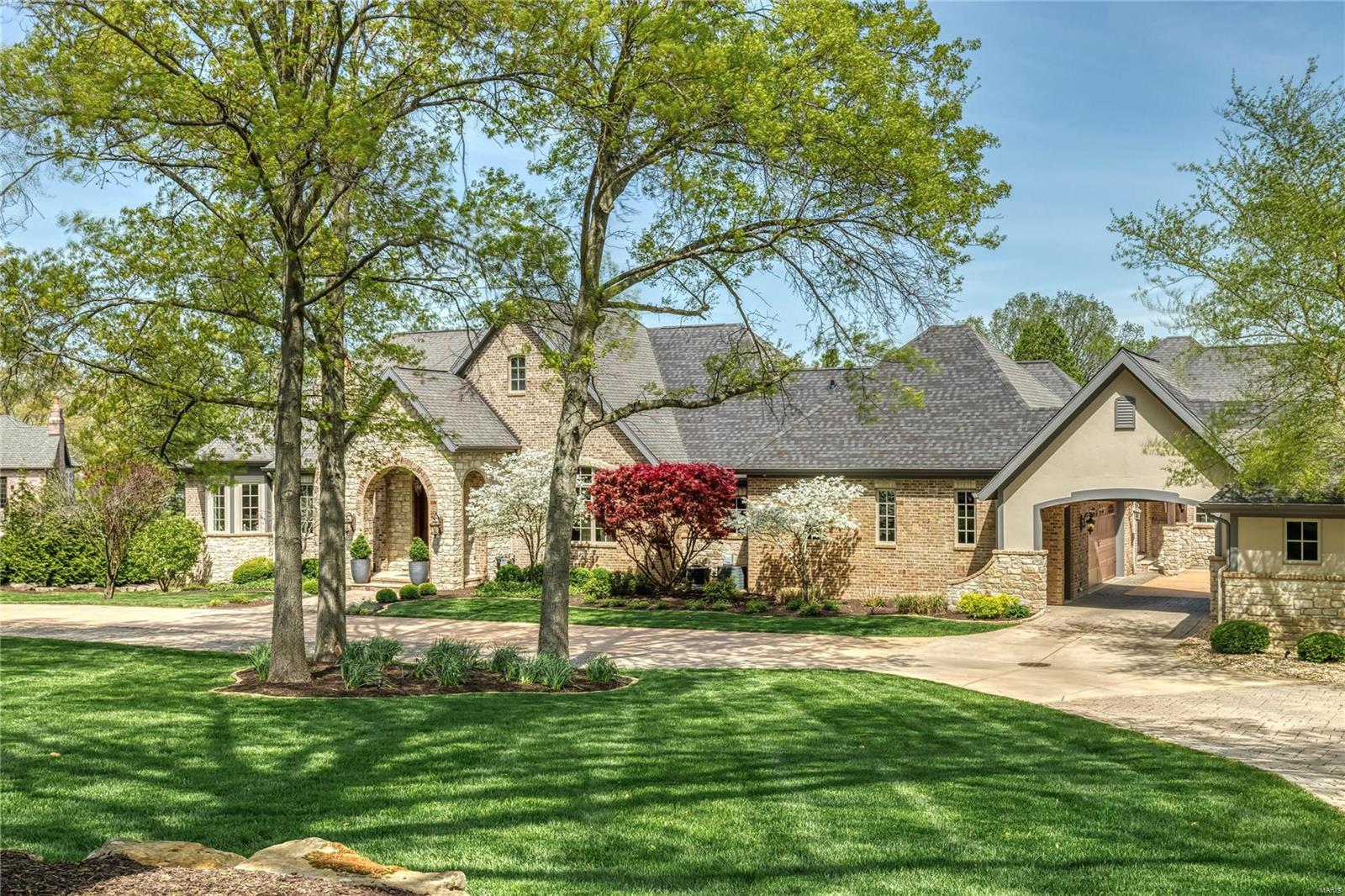 This magnificent 11,015 sf Estate home redefines luxury living. Stunning foyer with domed ceiling & floating staircase leads to library-paneled study with marble fireplace & built-in bookcases, barrel-vaulted dining room & spectacular great room with bank of windows & brick & stone fireplace flanked by bookcases. Designer kitchen with cherry cabinetry, quartzite countertops & commercial grade appliances adjoins light-filled breakfast room, vaulted hearth room highlighted by floor-to-ceiling stone fireplace & coffered family room.  Primary bedroom suite with beautifully appointed bath with freestanding tub & private deck plus 3 additional ensuite bedrooms complete the main floor living quarters. Rear staircase accesses 2nd floor apartment with private entrance. Lower Level includes recreation room with 4th fireplace, game room, media room, gathering bar, workout room, 2 guest suites & ½ bath. Situated on parklike 3+ acre grounds with patio, pool with waterfall, pool room & 6-car garage.