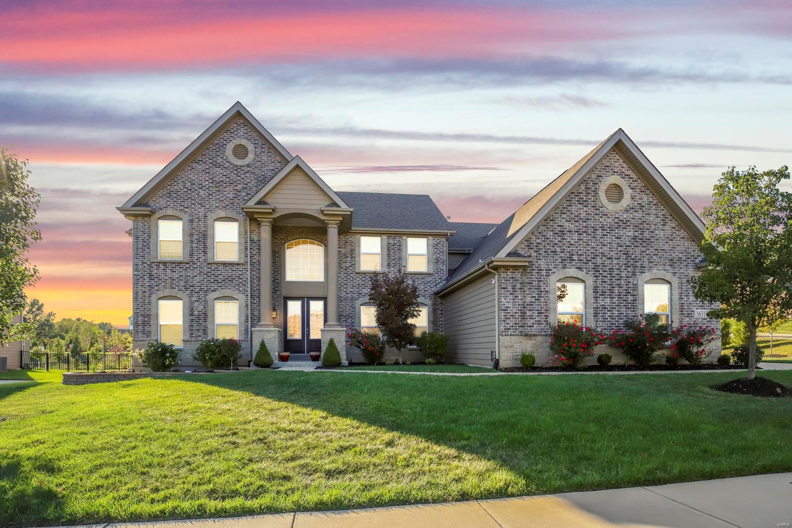 Stunning 1.5-Sty home, sits on a spacious .63 acre lot in the sought after Arbors at Kehrs Mill, in Chesterfield! 4 Beds, 3.5 Baths & 4,800+ square feet! Kitchen boasts Cambria quartz counters, stacked cabinetry with glass & crown molding, under cabinet lighting, SS appliances, 6 burner gas range, island with breakfast bar, glass tile backsplash, desk, walk-in pantry & Sunroom. Highlights: 3 car garage, 240v hookup for electric car charger, integrated water softening system, zoned HVAC, irrigation system, Goalsetter basketball hoop, premium elevation, landscape lighting, 10ft doors & painted neutral colors throughout. Phenomenal outdoor living! 2,000+ sqft patio with porcelain tiles - Outdoor Kitchen features granite, sink, double gas burner, Blaze Premium gas grill, EVO Flat Top Grill, built-in drawers & trash can. Professionally landscaped yard, wrought iron fence with multiple arched gates & gate for mower access, Belgard paver walkway & garden area! Additional Rooms: Mud Room
